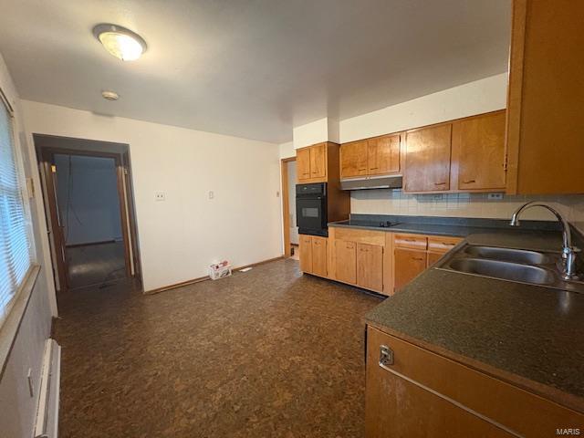 kitchen featuring tasteful backsplash, dark countertops, a sink, black appliances, and under cabinet range hood
