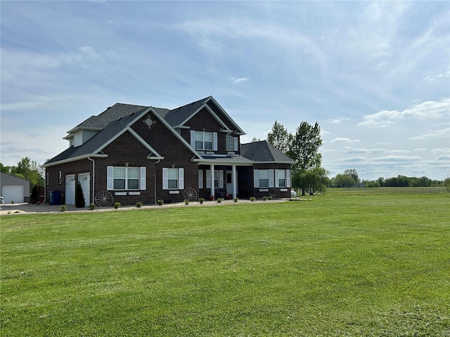 craftsman house with a front yard, brick siding, and a garage