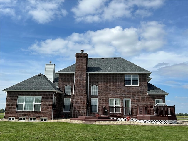 rear view of house featuring a wooden deck, a yard, a shingled roof, and a chimney