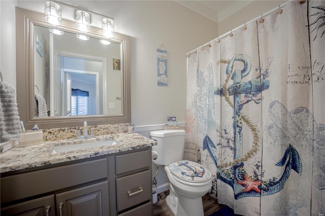 bathroom with curtained shower, crown molding, toilet, wood finished floors, and vanity