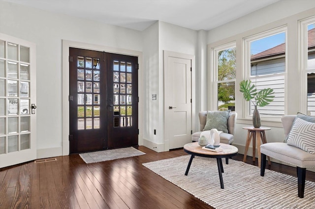 entryway featuring baseboards, visible vents, hardwood / wood-style flooring, and french doors