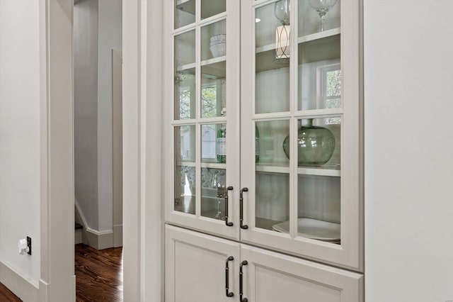 interior space with baseboards and wood finished floors