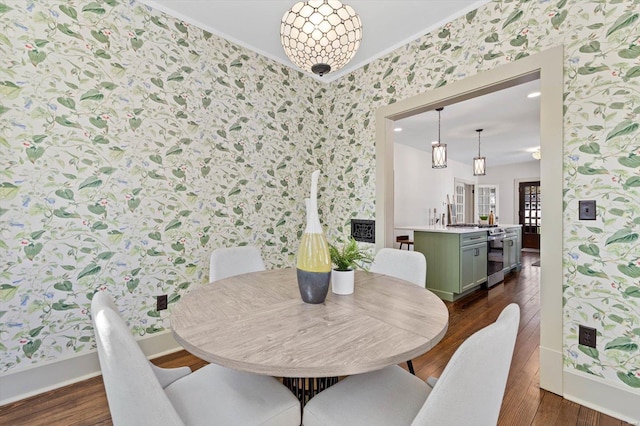 dining space featuring wallpapered walls