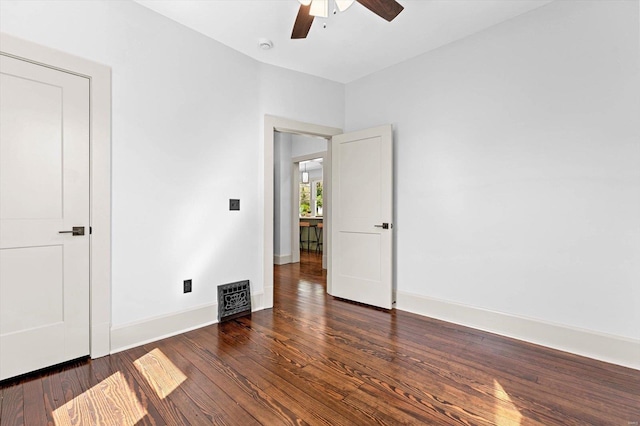 unfurnished bedroom with wood finished floors, a ceiling fan, and baseboards