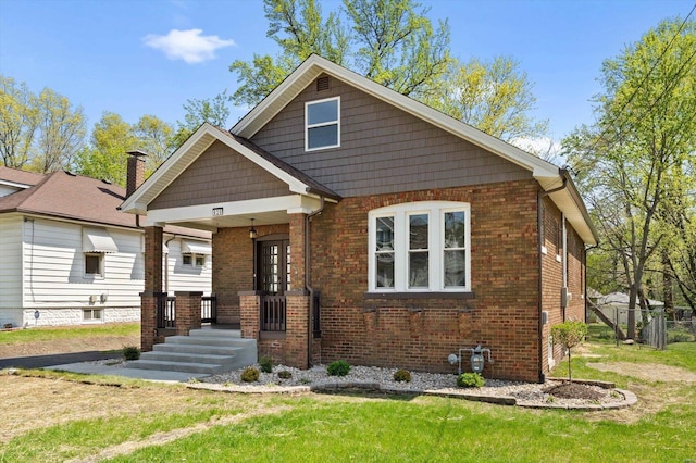 view of front of property with brick siding and a front yard