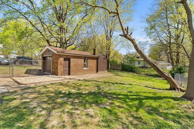view of yard with an outdoor structure, a storage unit, and fence
