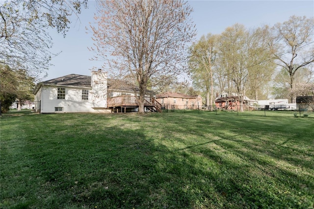 view of yard with a fenced backyard and a wooden deck