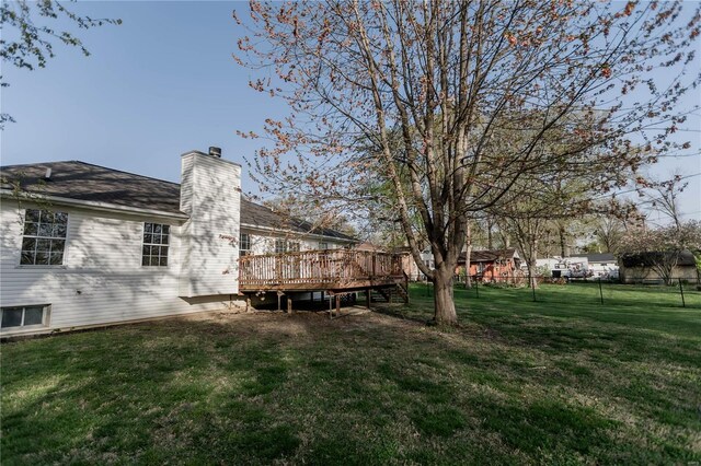 view of yard featuring fence and a deck