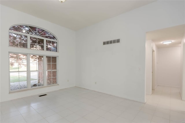 empty room featuring visible vents and light tile patterned floors