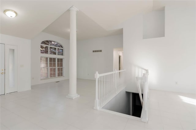 interior space featuring visible vents, tile patterned floors, and ornate columns