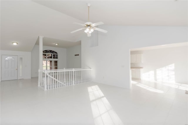 empty room featuring lofted ceiling and a ceiling fan