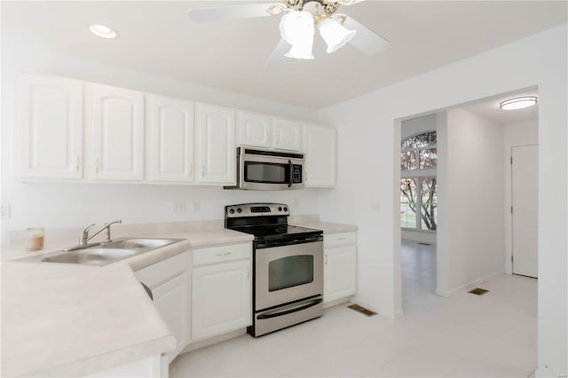 kitchen with white cabinets, a ceiling fan, stainless steel appliances, and a sink