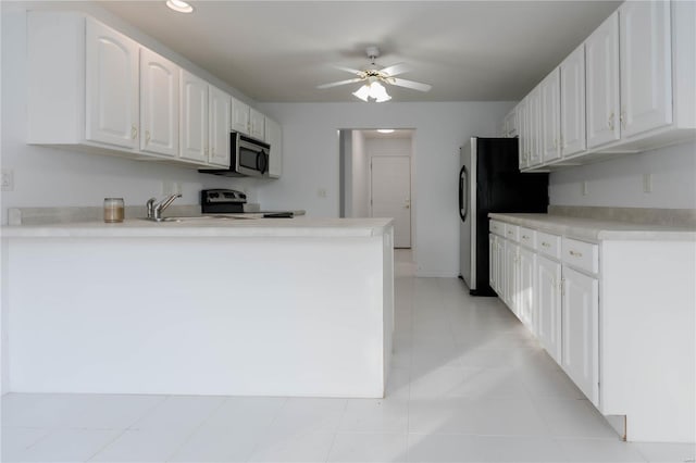 kitchen featuring a peninsula, white cabinetry, a ceiling fan, light countertops, and appliances with stainless steel finishes
