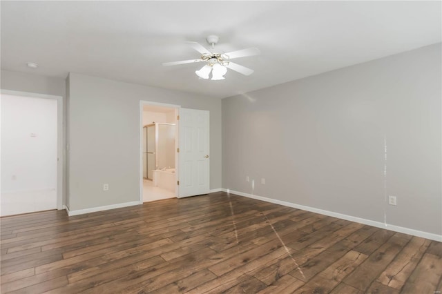 spare room with baseboards, a ceiling fan, and dark wood-style floors