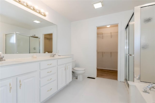 bathroom with a sink, double vanity, and a stall shower