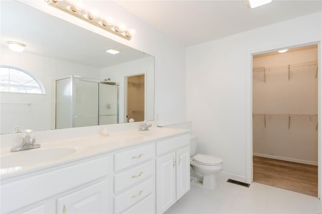 full bathroom with a sink, double vanity, toilet, a stall shower, and visible vents