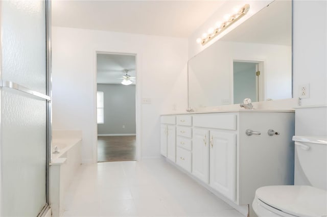 full bathroom featuring tile patterned floors, toilet, vanity, a bath, and ceiling fan