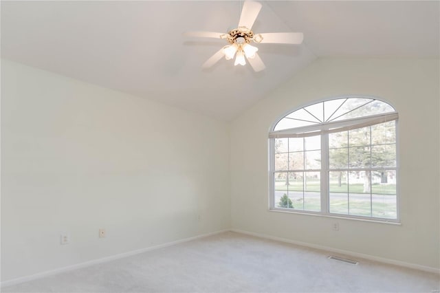 unfurnished room featuring lofted ceiling, baseboards, visible vents, and light colored carpet