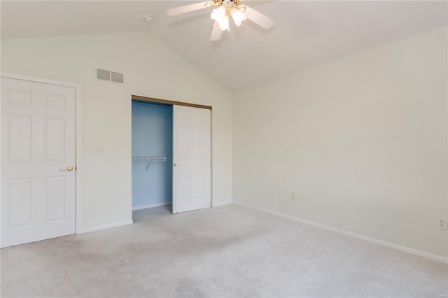unfurnished bedroom with baseboards, vaulted ceiling, visible vents, and carpet