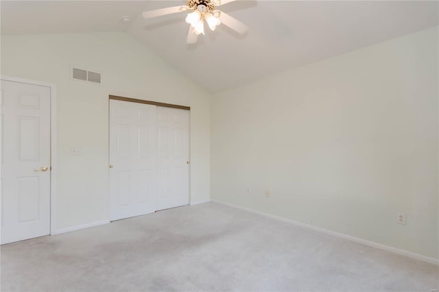 unfurnished bedroom with baseboards, lofted ceiling, visible vents, and carpet