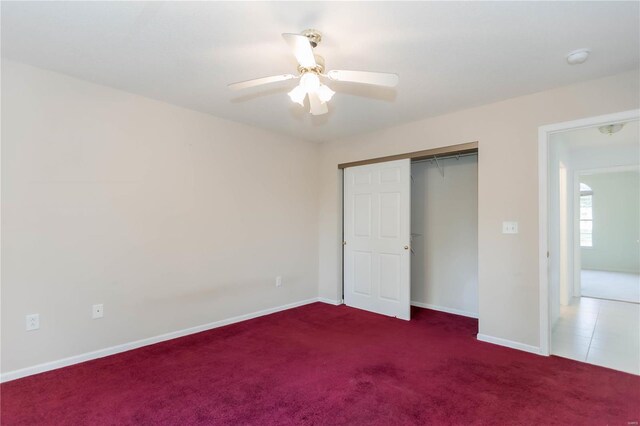 unfurnished bedroom featuring baseboards, a ceiling fan, carpet flooring, and a closet