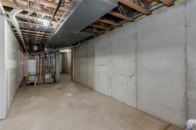 unfinished basement featuring water heater and heating unit