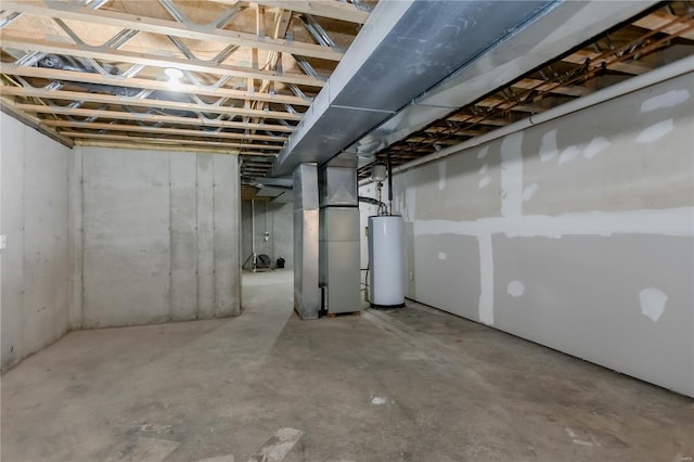 unfinished below grade area featuring heating unit and gas water heater