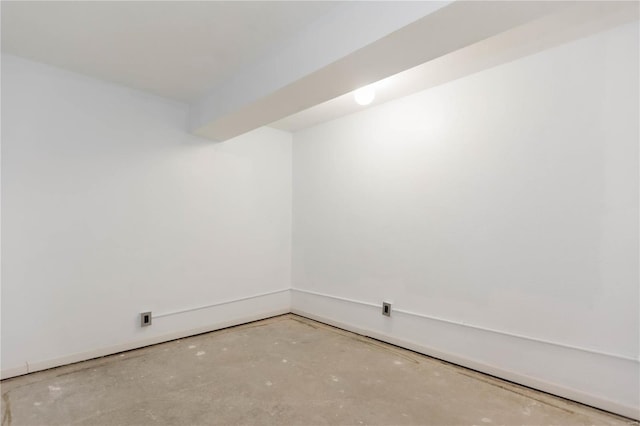 empty room with unfinished concrete flooring