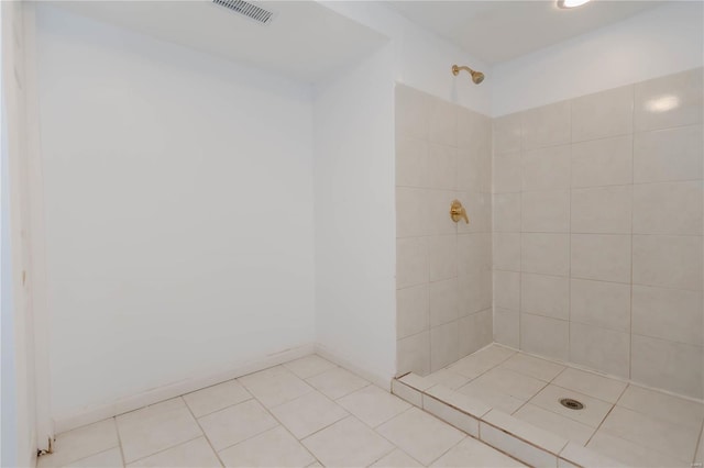 bathroom with a tile shower, tile patterned floors, and visible vents