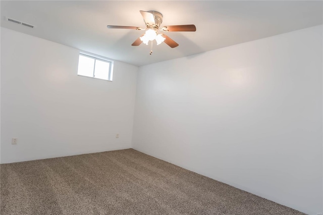 empty room with ceiling fan, carpet floors, and visible vents