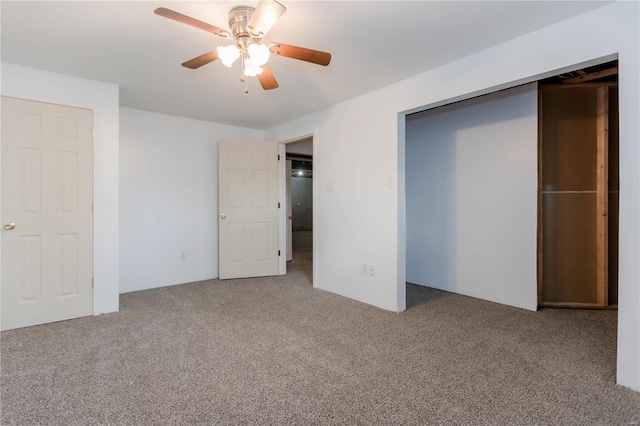unfurnished bedroom with a ceiling fan, carpet flooring, and a closet