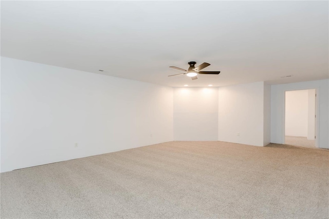 spare room featuring ceiling fan and light carpet