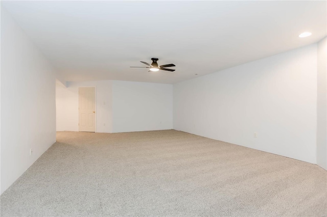 unfurnished room featuring carpet flooring and a ceiling fan