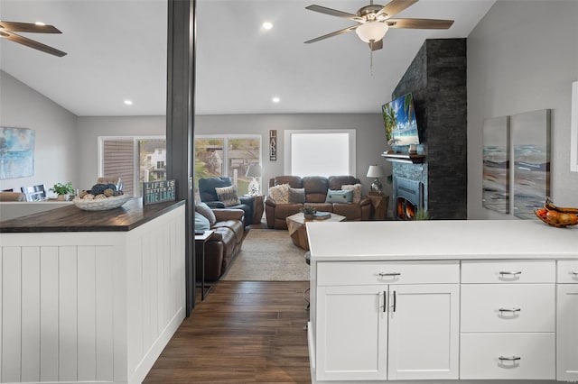 kitchen with lofted ceiling, open floor plan, a ceiling fan, and dark wood-style floors