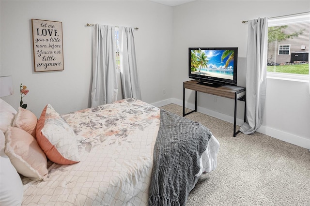 bedroom featuring carpet floors and baseboards