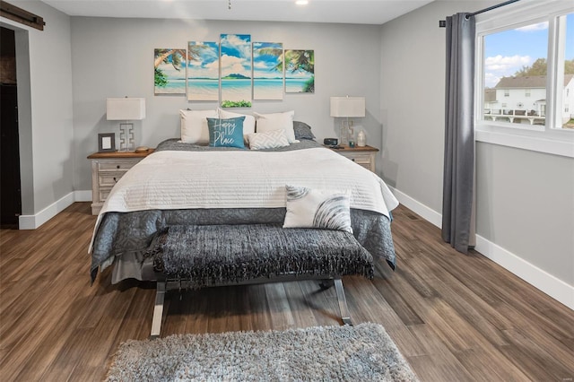 bedroom with wood finished floors and baseboards