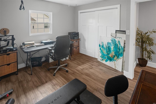 home office featuring wood finished floors and baseboards