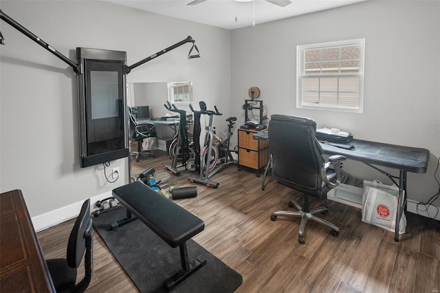 office area with baseboards, a ceiling fan, and wood finished floors