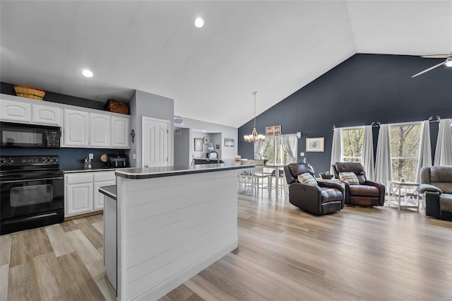 kitchen with white cabinets, open floor plan, an inviting chandelier, high vaulted ceiling, and black appliances