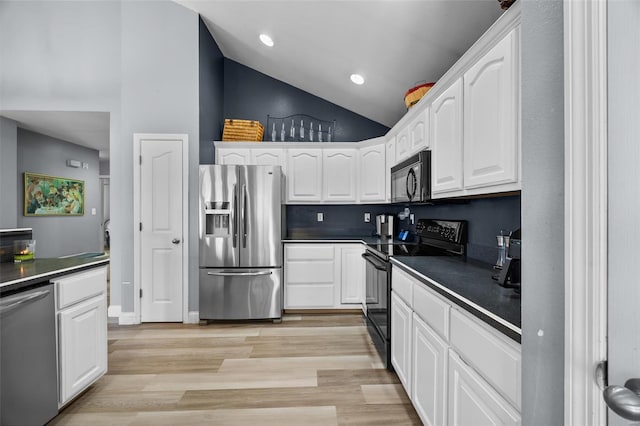 kitchen featuring dark countertops, black appliances, light wood-type flooring, white cabinetry, and recessed lighting