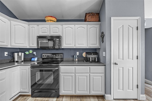 kitchen featuring black appliances and white cabinets