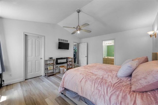 bedroom with vaulted ceiling, wood finished floors, ceiling fan, baseboards, and visible vents
