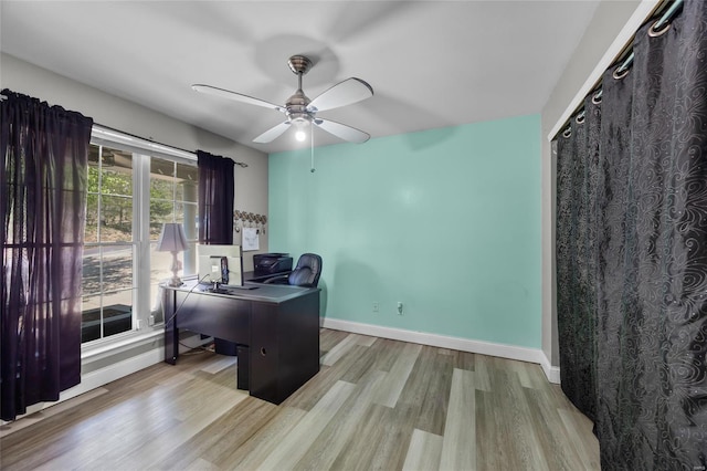 office space with baseboards, a ceiling fan, and wood finished floors