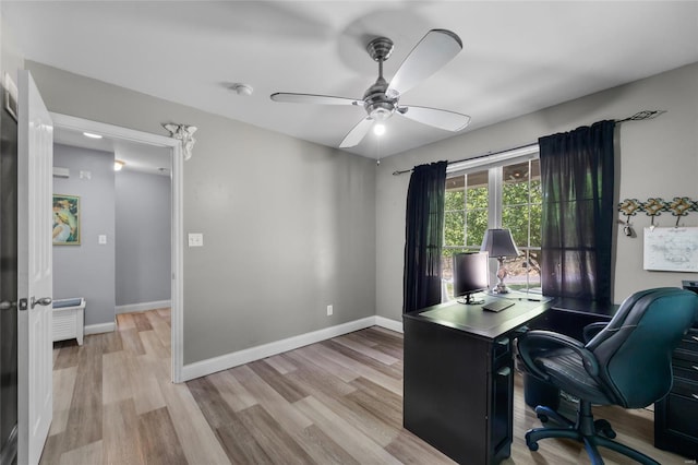 office featuring wood finished floors, a ceiling fan, and baseboards