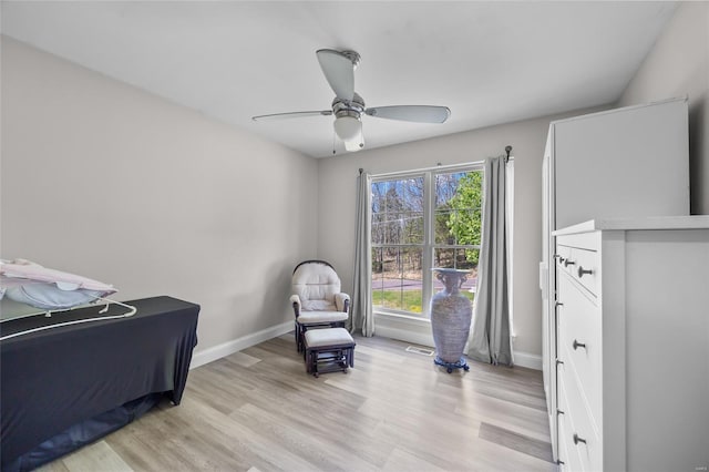 bedroom featuring light wood finished floors, baseboards, and multiple windows