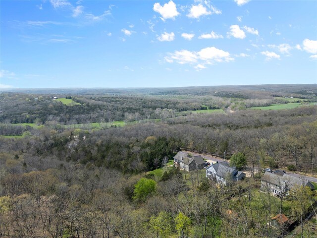 drone / aerial view featuring a wooded view
