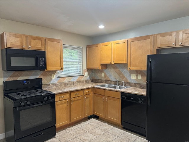 kitchen featuring light countertops, light tile patterned floors, a sink, black appliances, and tasteful backsplash