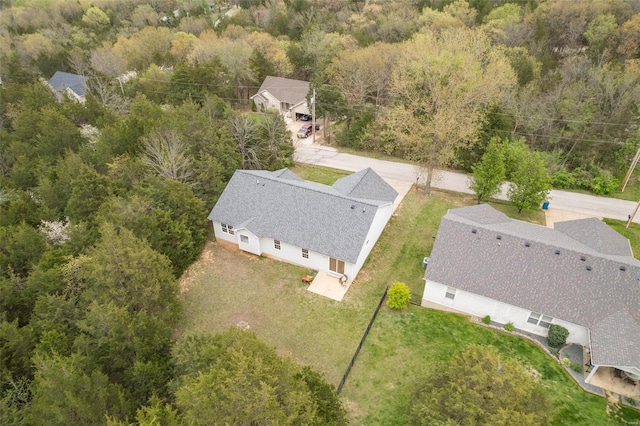 drone / aerial view with a wooded view