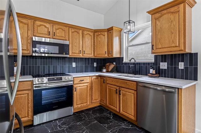 kitchen featuring light countertops, stainless steel appliances, and a sink