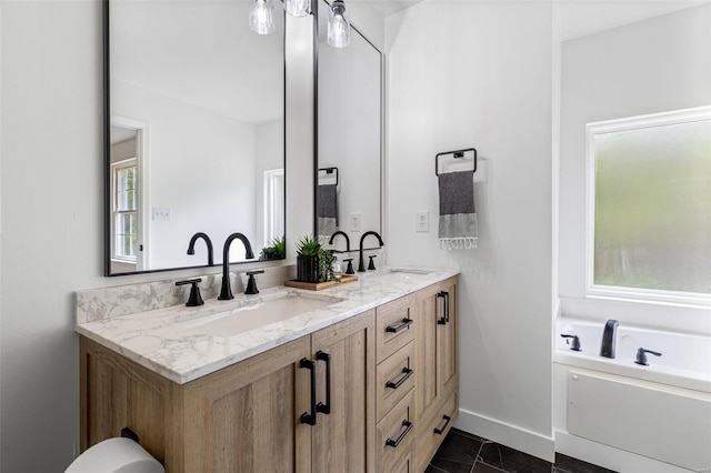 full bathroom featuring a bath, double vanity, baseboards, and a sink